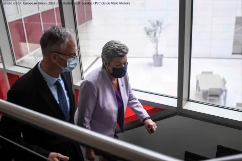 EMCDDA Director Alexis Goosdeel welcomes European Commissioner for Home Affairs Ylva Johansson climbing stairs at the EMCDDA in Lisbon