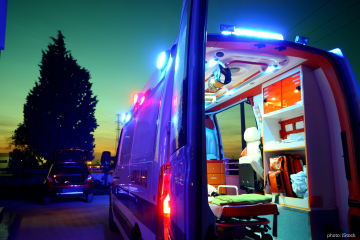 An ambulance parked on the street at night