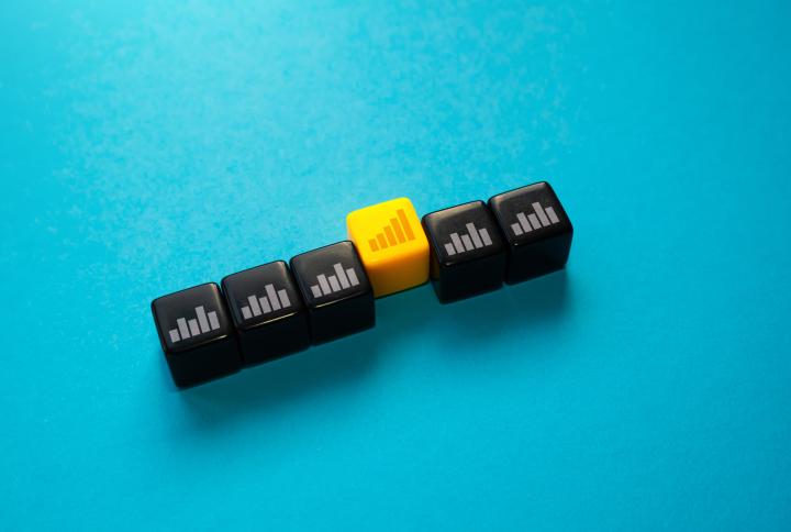 five black dice and one yellow dice with trends columns