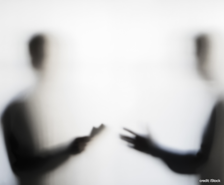 blurred image of two people talking