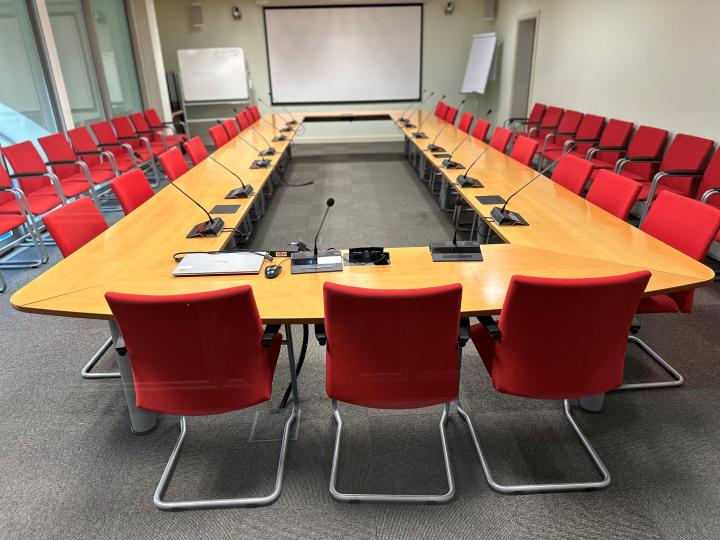 meeting room with oval wooden table and rec chairs